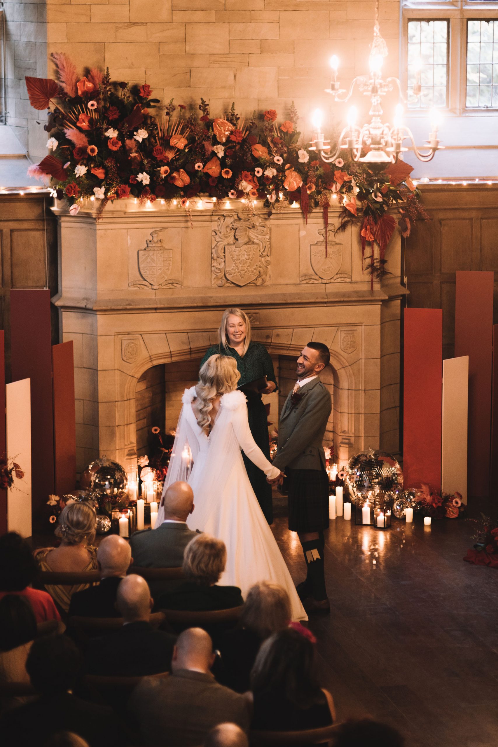 couple getting married at Achnagairn Castle with rich toned florals and modern ceremony backdrops