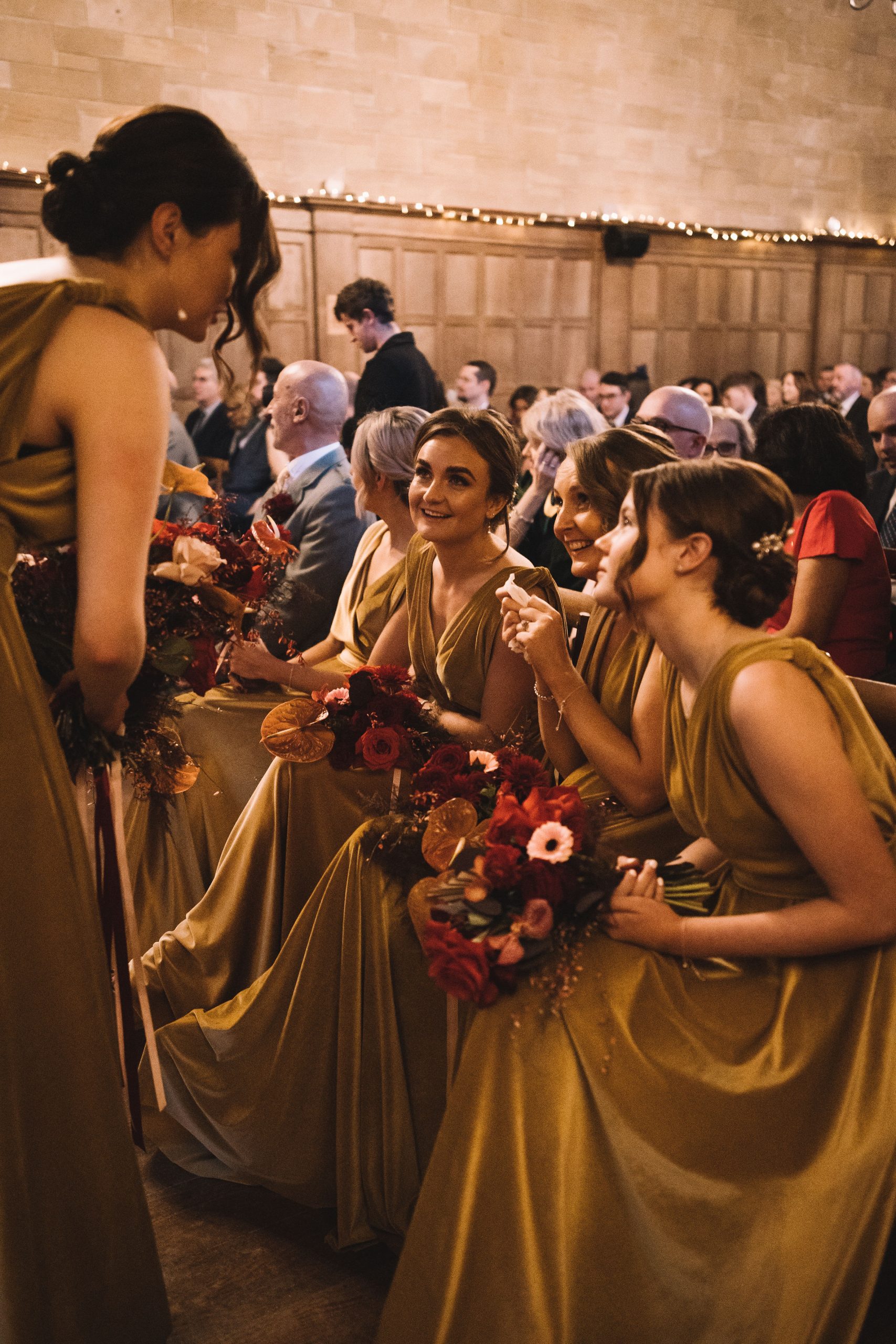 Bridesmaid in ceremony in gold bridesmaid dresses