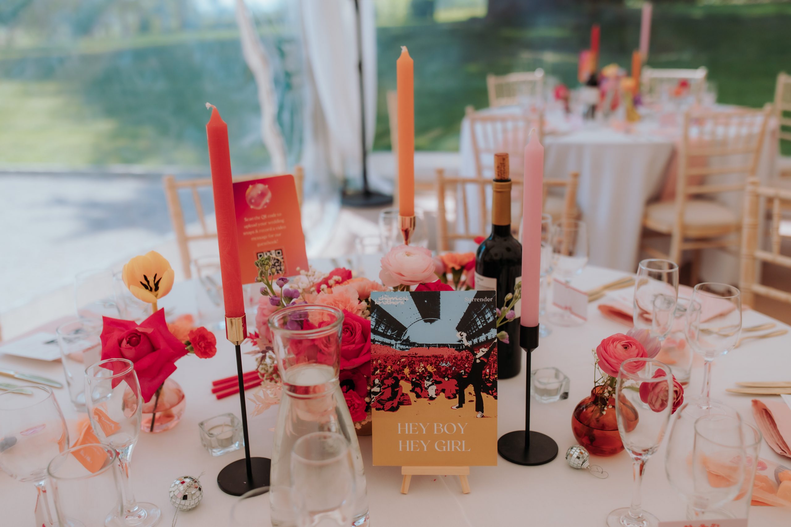 a colourful table design with lots of pink and oraneg flowers. The table name is hey boy hey girl album cover