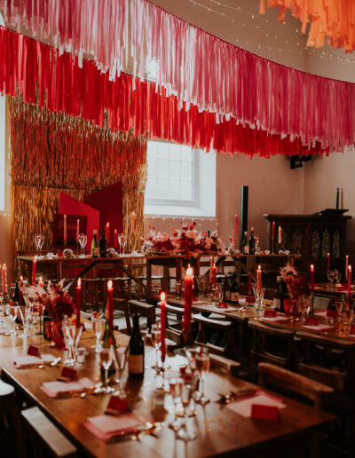 red and pink wedding table styling at the globe
